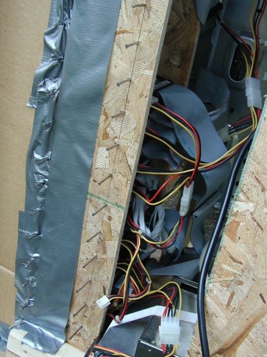 The nails are driven in to rest the hard drives on.  The spacing is such that there is about a half inch between all the drives for air to flow through.  Open space is blocked off with cardboard so the air is forced through the drives.