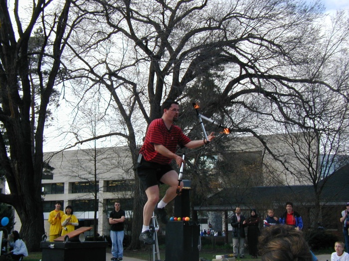 Juggling fire on a really high unicycle.