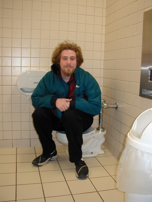 Russ, sitting on the mini-me toilet.  Also known as a kid's toilet.
