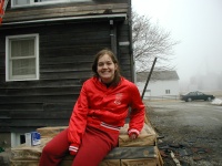 Becki sitting on the pallet of shingles