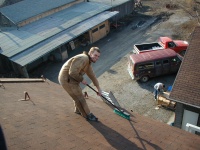 Jeremy sweeping off some of the roofing grit.