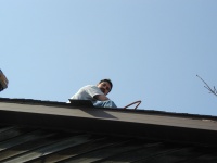 Tony peering over the edge of the roof.