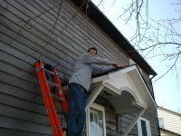 Michael working on the front roof, putting up shingles.