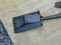 One of the shovels used to remove shingles.  It grabs the shingles and nails, and pries them out.