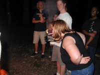 Erica succeeding in lighting her cigarette from the fire.