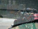 Some ATVs on the back of a truck, and a sign.  I don't remember why I took this photo.