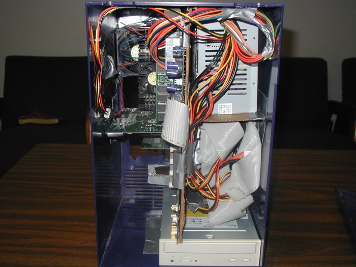 Cardboard is used to hold everything up and together.  The mainboard fits beautifully, friction fit.  The DVD drive fits along the bottom and is accessed by popping the front off.
