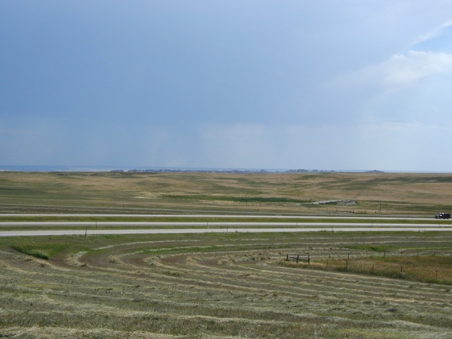 Badlands, and a storm in the distance.
