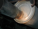 The left muffler.  Rust is evident around the tip joint.